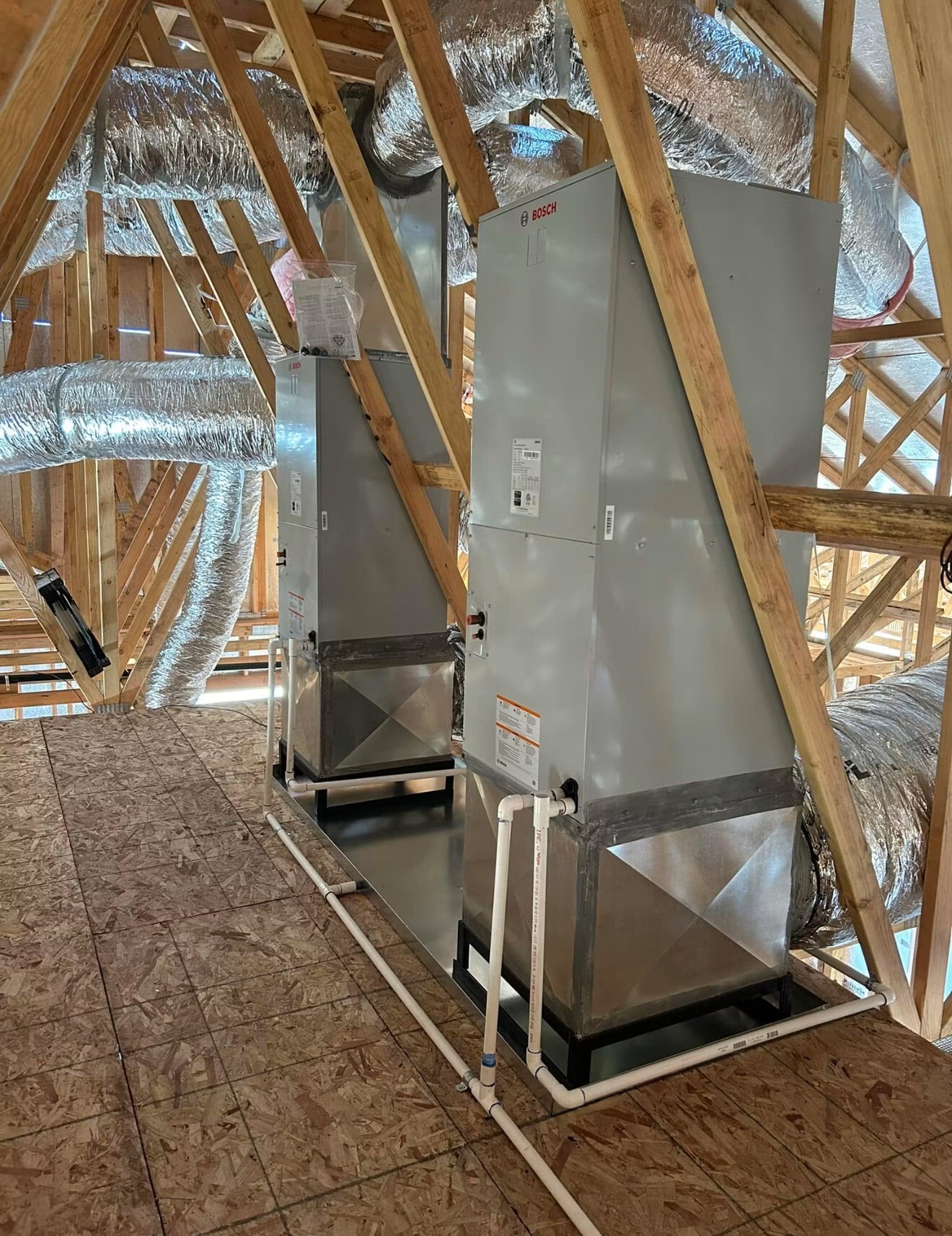 Two air handlers installed in a home's attic during new construction