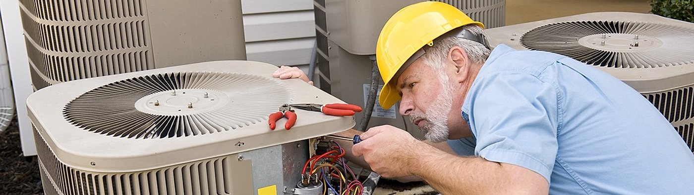 Technician repairing a residential condenser unit